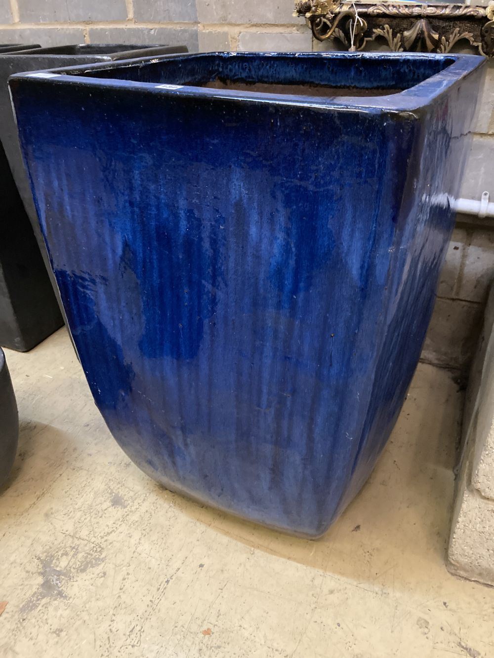 A large blue glazed square garden planter, width 63cm height 90cm